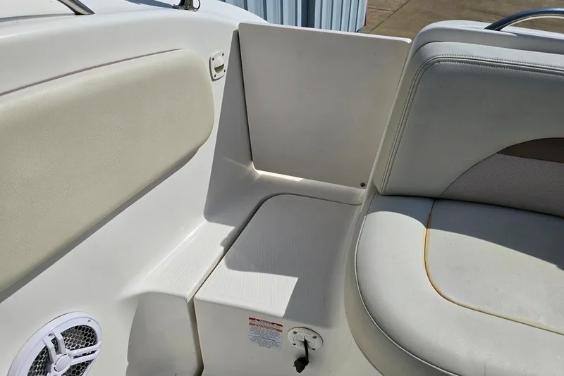 Slide: The Image of 2005 Chaparral Sunesta 254 boat interior seating with speaker and storage compartment. - 6