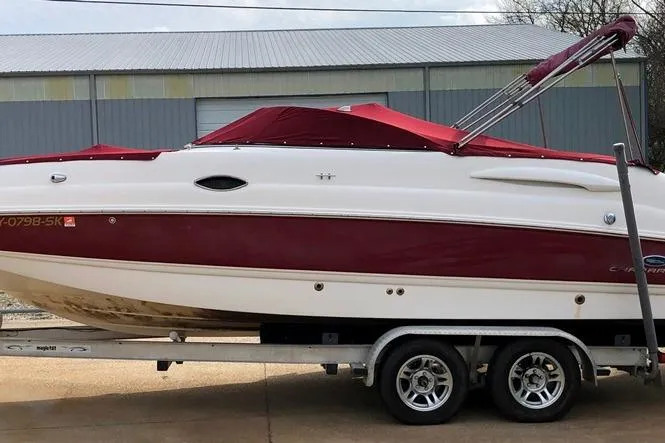 Slide: The Image of 2005 Chaparral Sunesta 254 boat on trailer, red and white design, parked outdoors. - 7