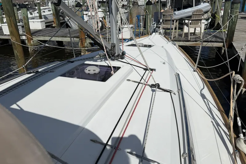 Slide: The Image of 2015 Jeanneau Sun Odyssey 349 sailboat docked at marina, showing deck and rigging. - 14