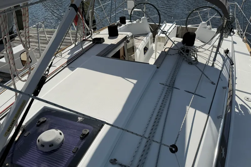 Slide: The Image of 2015 Jeanneau Sun Odyssey 349 sailboat deck with rigging and dual steering wheels. - 17