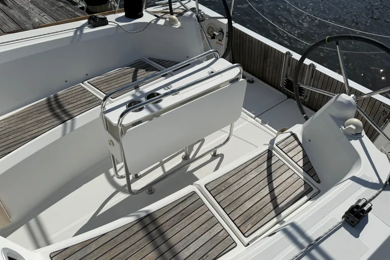 Slide: The Image of Cockpit of 2015 Jeanneau Sun Odyssey 349 sailboat with teak flooring and folding table. - 18