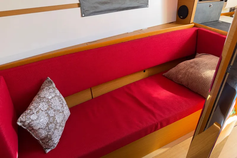 Slide: The Image of Red cushioned seating area inside 2015 Jeanneau Sun Odyssey 349 yacht. - 22