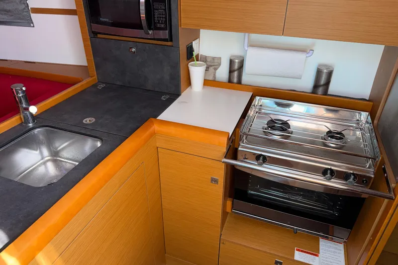 Slide: The Image of Compact kitchen in 2015 Jeanneau Sun Odyssey 349 yacht with stove and sink. - 26