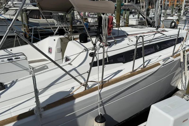 Slide: The Image of 2015 Jeanneau Sun Odyssey 349 sailboat docked at marina, featuring sleek design and modern rigging. - 3
