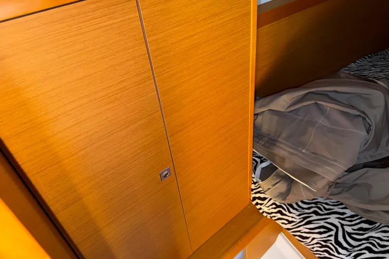 Slide: The Image of Interior cabin of 2015 Jeanneau Sun Odyssey 349 with wooden paneling and zebra-patterned bedding. - 31