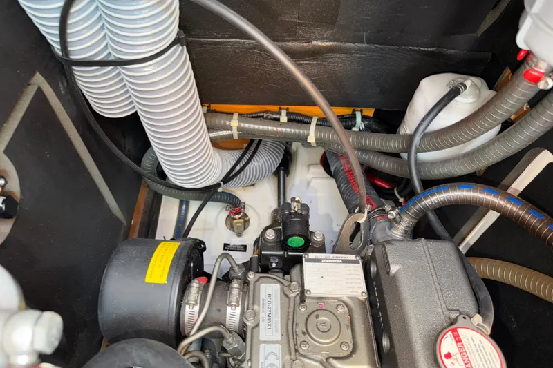 Slide: The Image of Engine compartment of a 2015 Jeanneau Sun Odyssey 349 sailboat, showing hoses and components. - 34