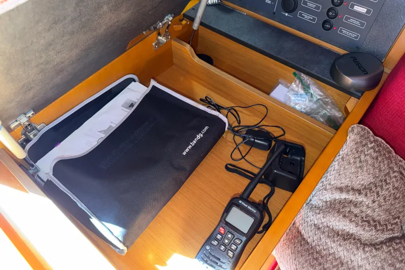 Slide: The Image of Navigation station on 2015 Jeanneau Sun Odyssey 349 with radio and documents. - 38
