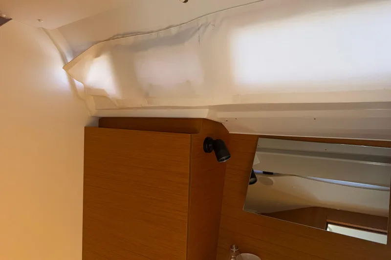 Slide: The Image of Interior of 2015 Jeanneau Sun Odyssey 349 yacht with wooden cabinetry and mirror. - 39