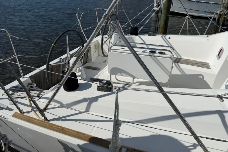Slide: The Image of Cockpit of 2015 Jeanneau Sun Odyssey 349 sailboat, featuring steering wheel and seating. - 4