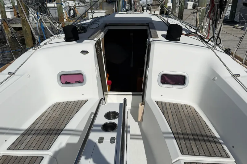 Slide: The Image of 2015 Jeanneau Sun Odyssey 349 sailboat cockpit with wooden seating and open cabin entrance. - 5