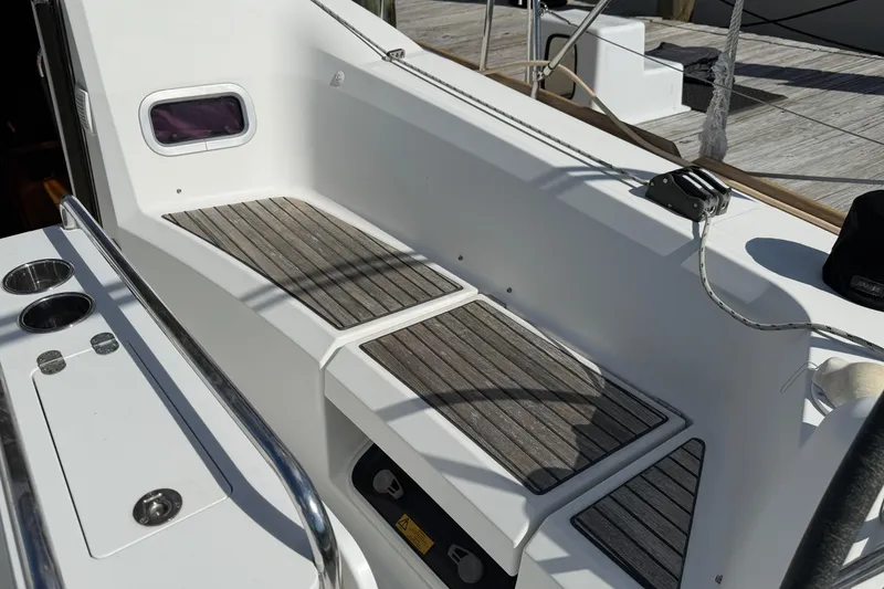 Slide: The Image of Cockpit of 2015 Jeanneau Sun Odyssey 349 sailboat with wooden seating and stainless steel fittings. - 7
