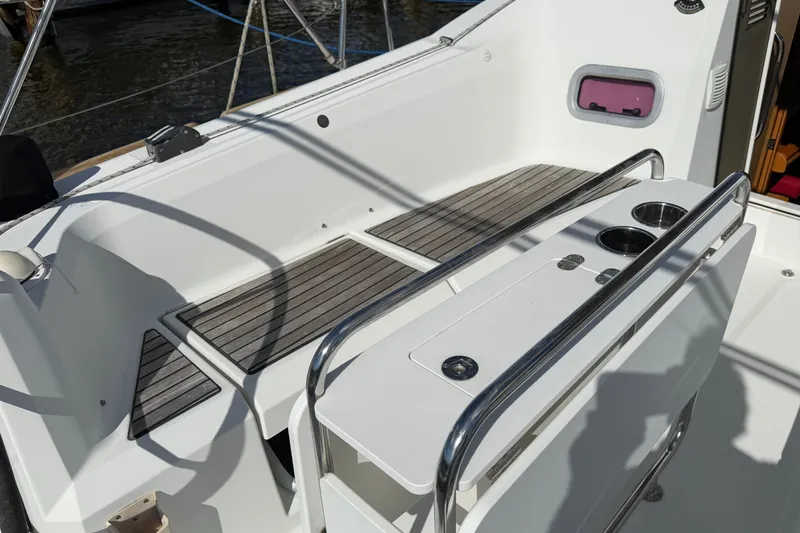 Slide: The Image of Cockpit of 2015 Jeanneau Sun Odyssey 349 sailboat with seating and cup holders. - 8