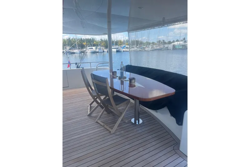 Slide: The Image of Outdoor dining area on 2018 Cheoy Lee Bravo 78 Sport Motor Yacht, overlooking marina. - 5