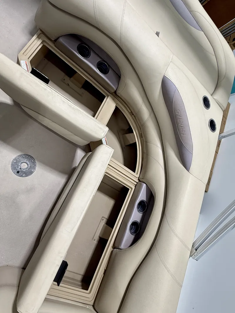 Slide: The Image of Interior of a 2017 Sylvan 8520 boat with seating and storage compartments. - 25