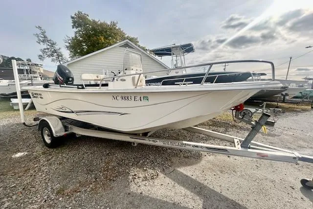 The Image of 2015 Carolina Skiff 198 DLV boat on trailer, parked outdoors. - 1