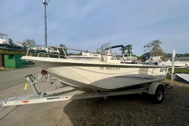 Slide: The Image of 2015 Carolina Skiff 198 DLV boat on trailer, parked outdoors. - 2