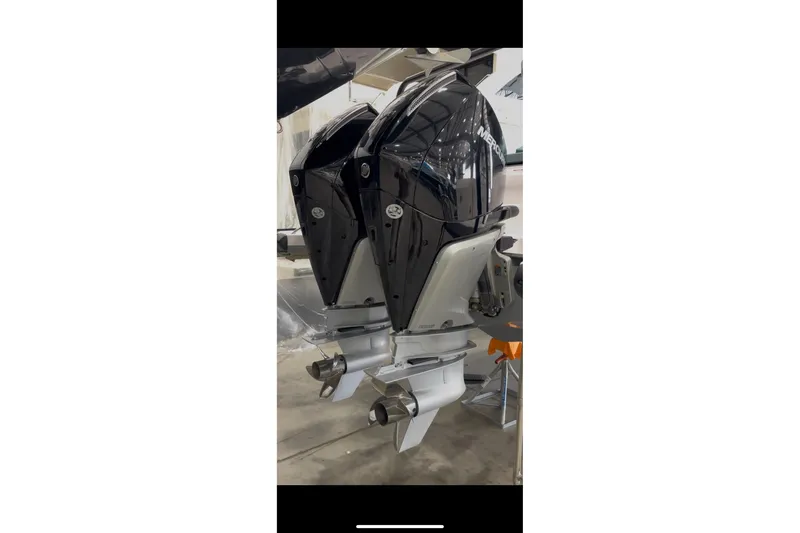 Slide: The Image of Twin outboard engines on a 2024 Axopar 37 XC Cross Cabin boat. - 12