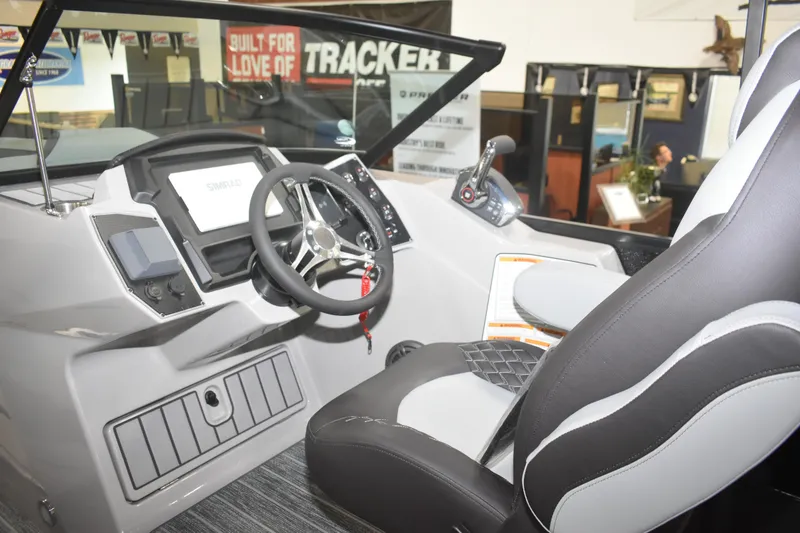 Slide: The Image of Interior of 2026 Premier 250 Solaris Sport boat, featuring modern steering and controls. - 13