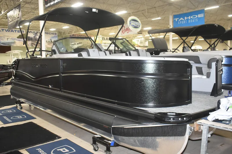 Slide: The Image of 2026 Premier 250 Solaris Sport pontoon boat displayed indoors at a showroom. - 3