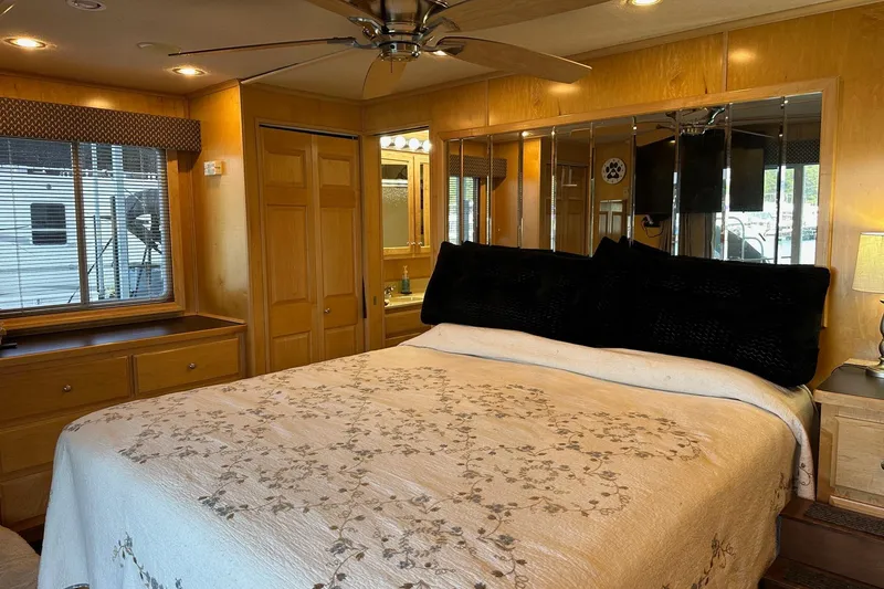 Slide: The Image of Luxurious bedroom in 2005 Starlite 16x82 houseboat with elegant decor and mirrored accents. - 12