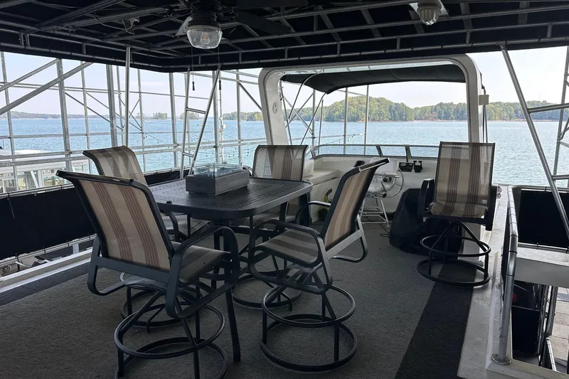 Slide: The Image of Upper deck of 2005 Starlite 16x82 houseboat with seating, overlooking serene lake view. - 14