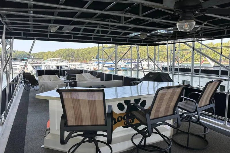 Slide: The Image of Spacious deck of 2005 Starlite 16x82 houseboat with seating and marina view. - 15