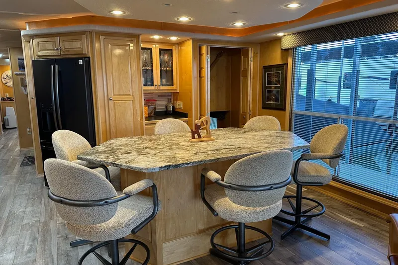 Slide: The Image of Luxurious kitchen interior in 2005 Starlite 16x82 houseboat with marble countertop and swivel chairs. - 6