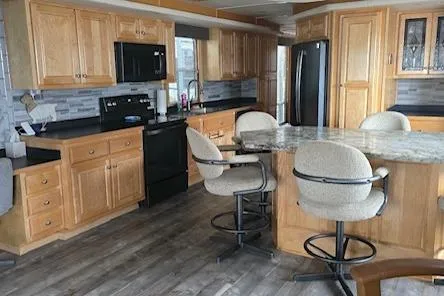 Slide: The Image of Spacious kitchen in 2005 Starlite 16x82 houseboat with wooden cabinets and modern appliances. - 7