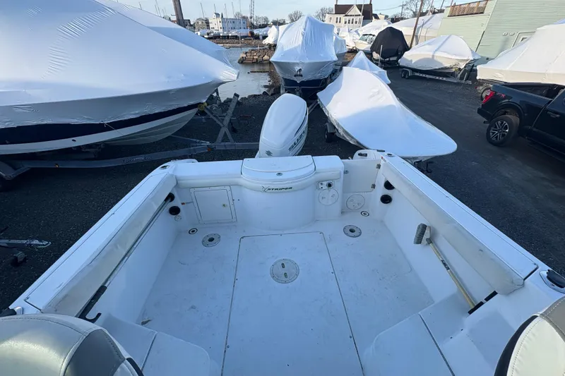Slide: The Image of 2002 Seaswirl Striper 2301 Walkaround O/B boat in storage yard, surrounded by covered boats. - 12