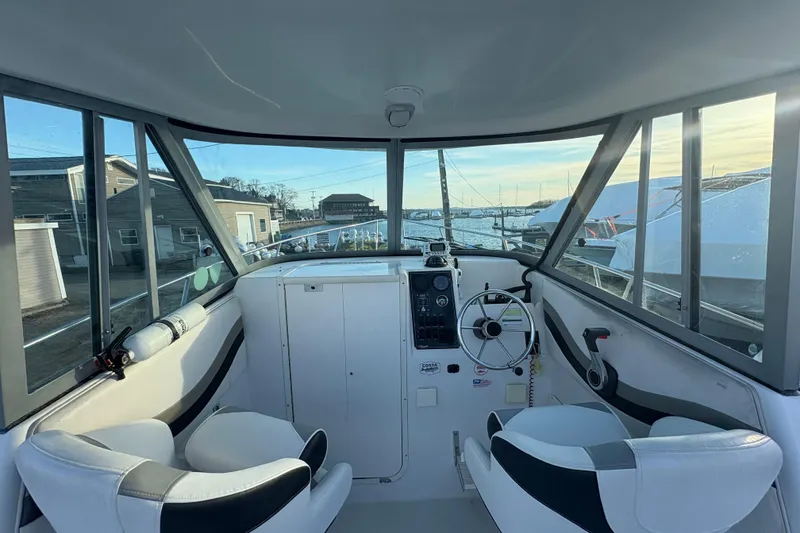 Slide: The Image of Interior view of 2002 Seaswirl Striper 2301 Walkaround O/B boat cockpit with steering wheel. - 17