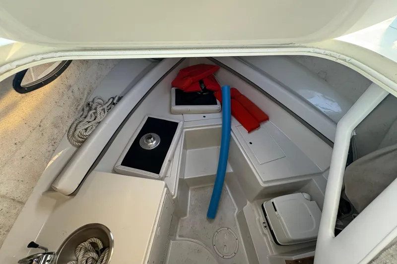 Slide: The Image of Interior of 2002 Seaswirl Striper 2301 Walkaround O/B with storage and safety equipment. - 18