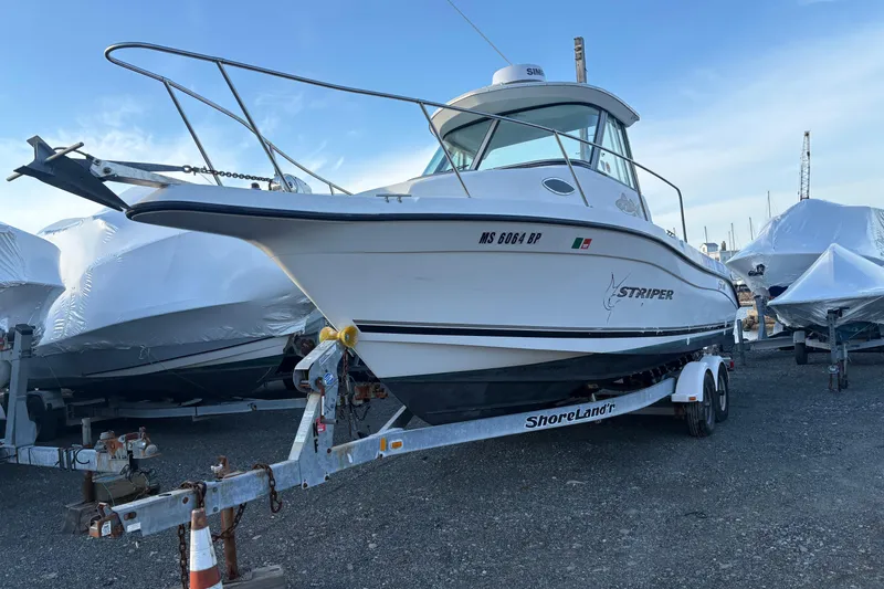 Slide: The Image of 2002 Seaswirl Striper 2301 Walkaround O/B on trailer, parked outdoors. - 2