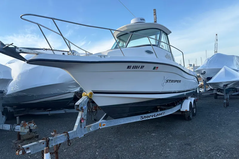 Slide: The Image of 2002 Seaswirl Striper 2301 Walkaround O/B boat on trailer, parked outdoors. - 3