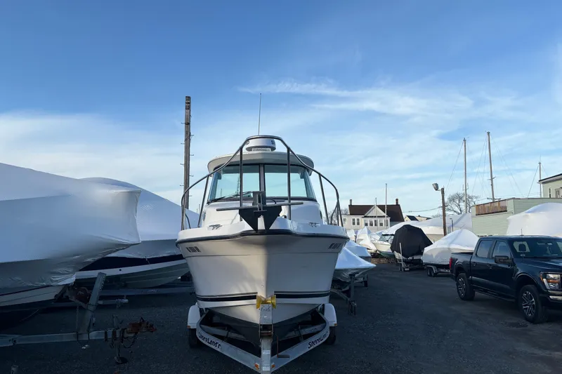 Slide: The Image of 2002 Seaswirl Striper 2301 Walkaround O/B boat on trailer in marina storage. - 4
