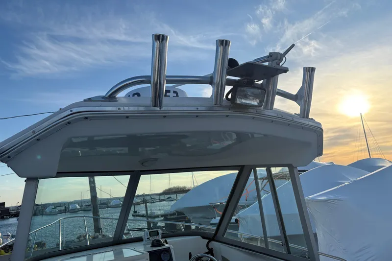 Slide: The Image of 2002 Seaswirl Striper 2301 Walkaround O/B boat with sunset background at marina. - 8