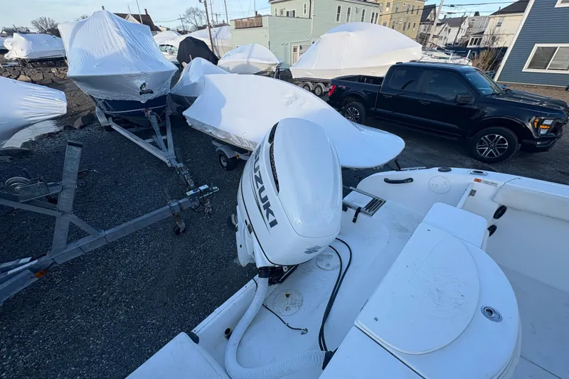 Slide: The Image of 2002 Seaswirl Striper 2301 Walkaround O/B with Suzuki outboard in storage yard. - 9