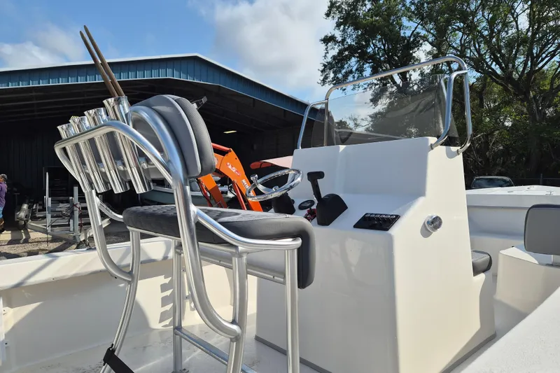 Slide: The Image of 2026 May-Craft 208 CC boat interior with helm, rod holders, and seating. - 2