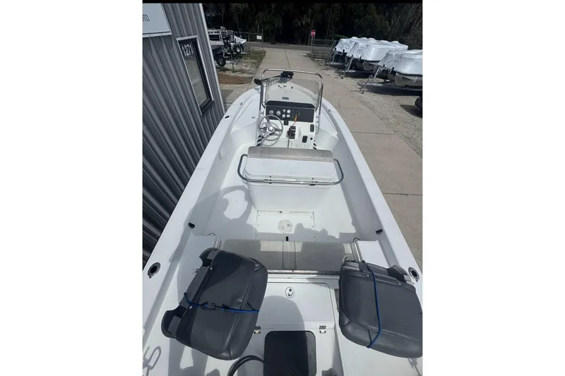 Slide: The Image of 2003 Ranger 2180 Bay Ranger boat interior with steering console and seating. - 4