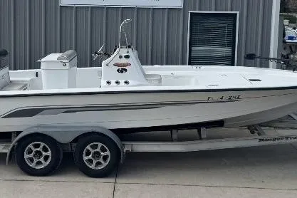 Slide: The Image of 2003 Ranger 2180 Bay Ranger boat on trailer, parked outside a building. - 6
