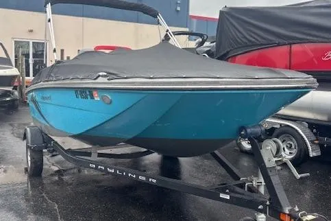 Slide: The Image of 2021 Bayliner Element E16 boat on trailer, covered, parked outdoors. - 12