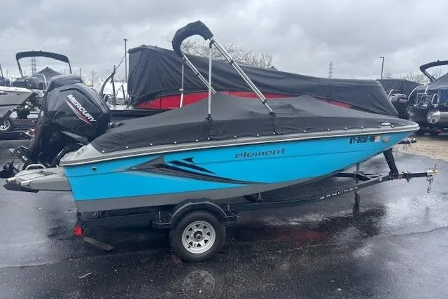 Slide: The Image of 2021 Bayliner Element E16 boat with cover on trailer, parked outdoors. - 13