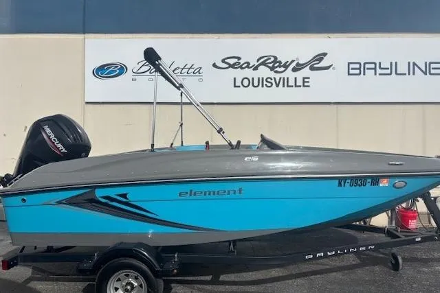 Slide: The Image of 2021 Bayliner Element E16 boat on trailer, displayed at dealership with branding signs. - 5