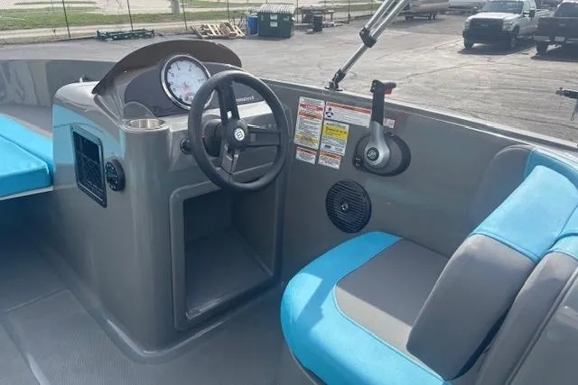 Slide: The Image of 2021 Bayliner Element E16 boat interior with steering wheel and blue seating. - 8