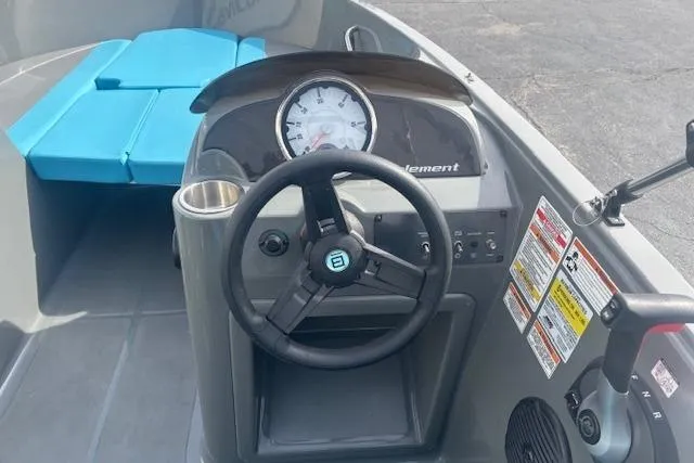 Slide: The Image of 2021 Bayliner Element E16 boat dashboard with steering wheel and gauges. - 9