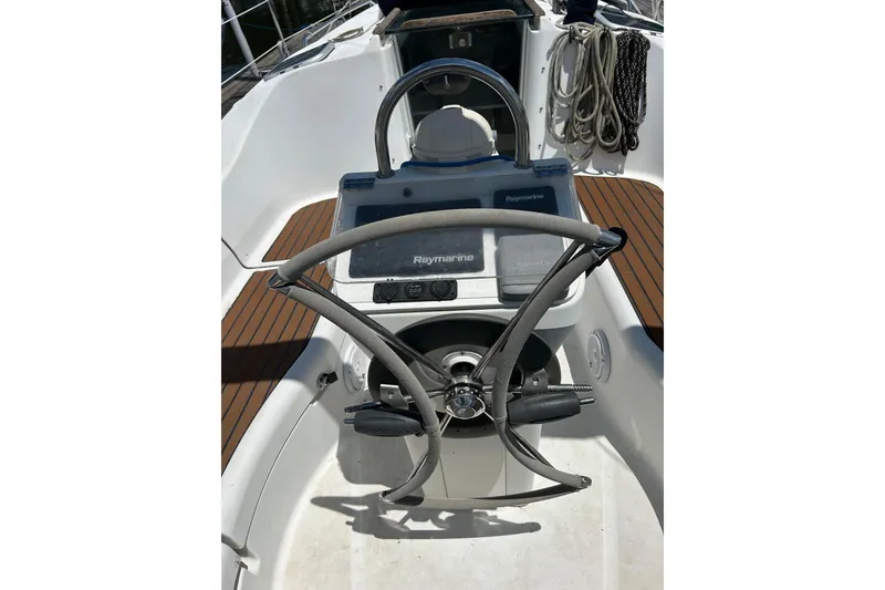 Slide: The Image of Steering wheel and controls of a 2004 Beneteau Oceanis Clipper 331 sailboat. - 28