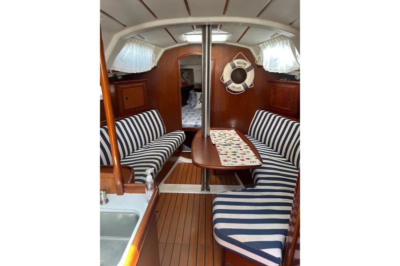 Slide: The Image of Interior of 2004 Beneteau Oceanis Clipper 331 with striped seating and wooden finishes. - 43