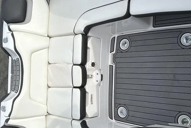 Slide: The Image of 2016 Yamaha Boats AR192 interior seating and deck, featuring sleek white and black design. - 11