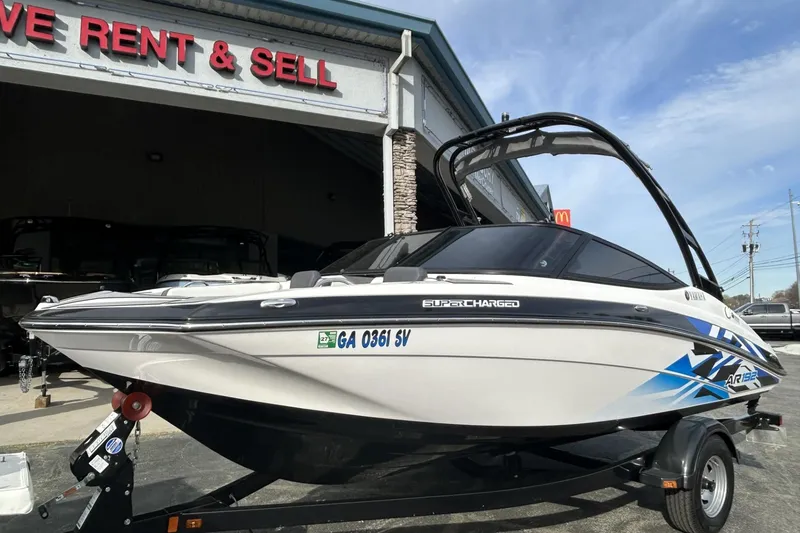 Slide: The Image of 2016 Yamaha AR192 boat on trailer outside a rent and sell shop. - 3