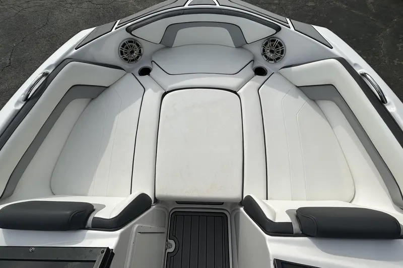 Slide: The Image of 2016 Yamaha Boats AR192 interior with white cushioned seating and speakers. - 9
