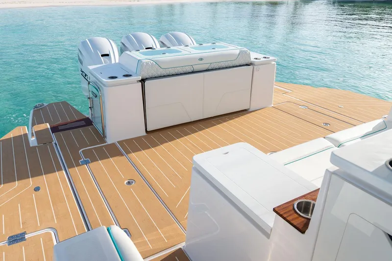 Slide: The Image of Manufacturer Provided Image: 2026 Regal 43 SAV boat deck with triple engines on clear water. - 11